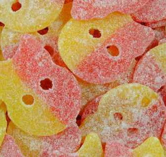 Close-up of pink and yellow skull candy BUBS. Orange and red colors