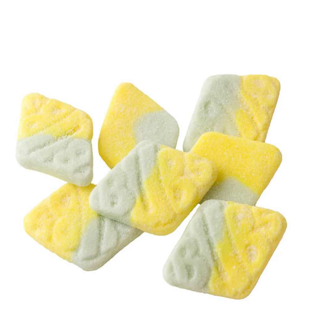 Yellow and green triangular candy on a white background marked BUBS