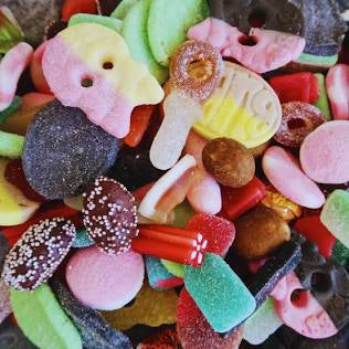 Assorted colorful candies including gummy bears, bubs and jelly beans.