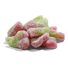 Bowl of red and green cherry gummy candies on a white background