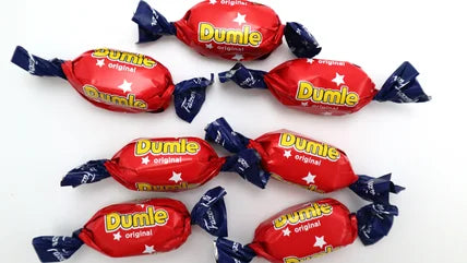 Red Dumle candies with blue wrappers on a white background