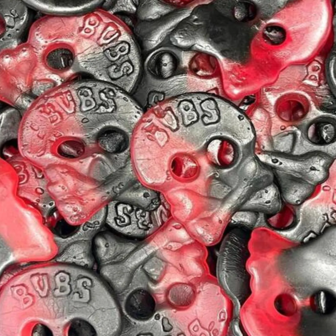 Close-up of red and black candy shaped as a skull marked 'BUBS'