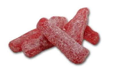 Red chewy candy shaped as bottles covered in white sour sugar. on a white background