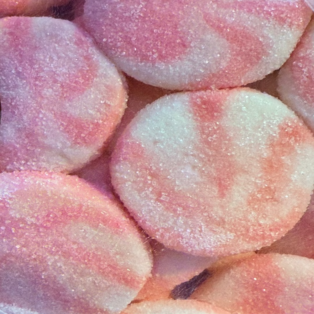 Close-up of pink and white striped candies with a textured surface.