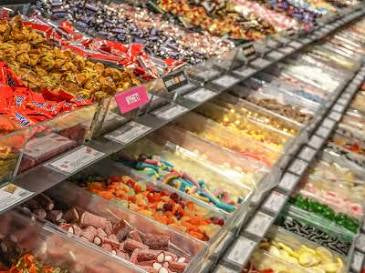 Display case with various snacks and candies in a swedish candy store
