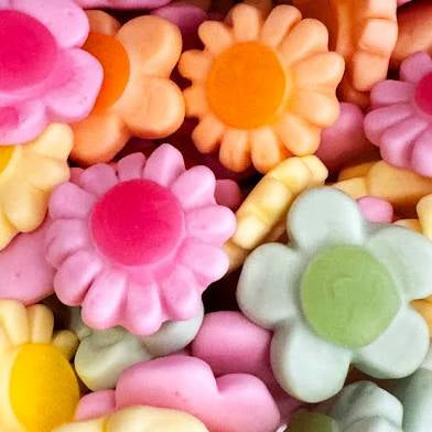 Colorful flower-shaped candies in various shades.