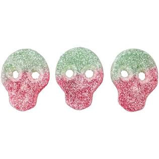 Three pink and green skull-shaped candy on a white background