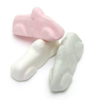 Two pairs of baby socks, one pink and one white, on a white background.
