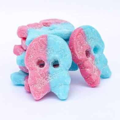 Pink and blue skull-shaped candies on a white background