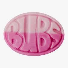 Pink oval candy with 'BUBS' text on a white background