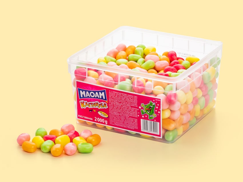 Box of colorful Maoam candies on a yellow background. 