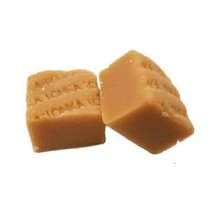 Two fudge pieces marked Lonka. The pieces are shaped as small cubes.