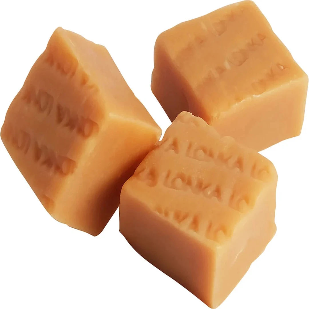 Three pieces of fudge with embossed text LONKA on a white background. Soft creamy swedish fudge. 