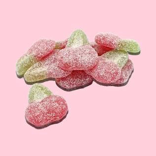 Gummy candy shaped like cherries. Color Blue and green coated in fizzy sugar. on a pink backgroundc