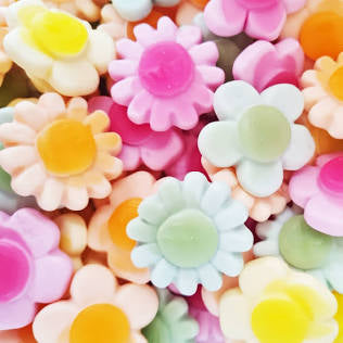 Colorful flower-shaped candies on a white background