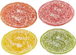 Four colorful gummy candies on a white background. Oval shaped covered in sour sugar.