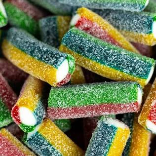 Assorted colorful jelly candy sticks on a white background