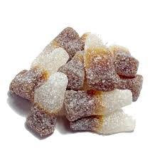 Chewy candy shaped as bottles two town brown and beige covered in sugar.
