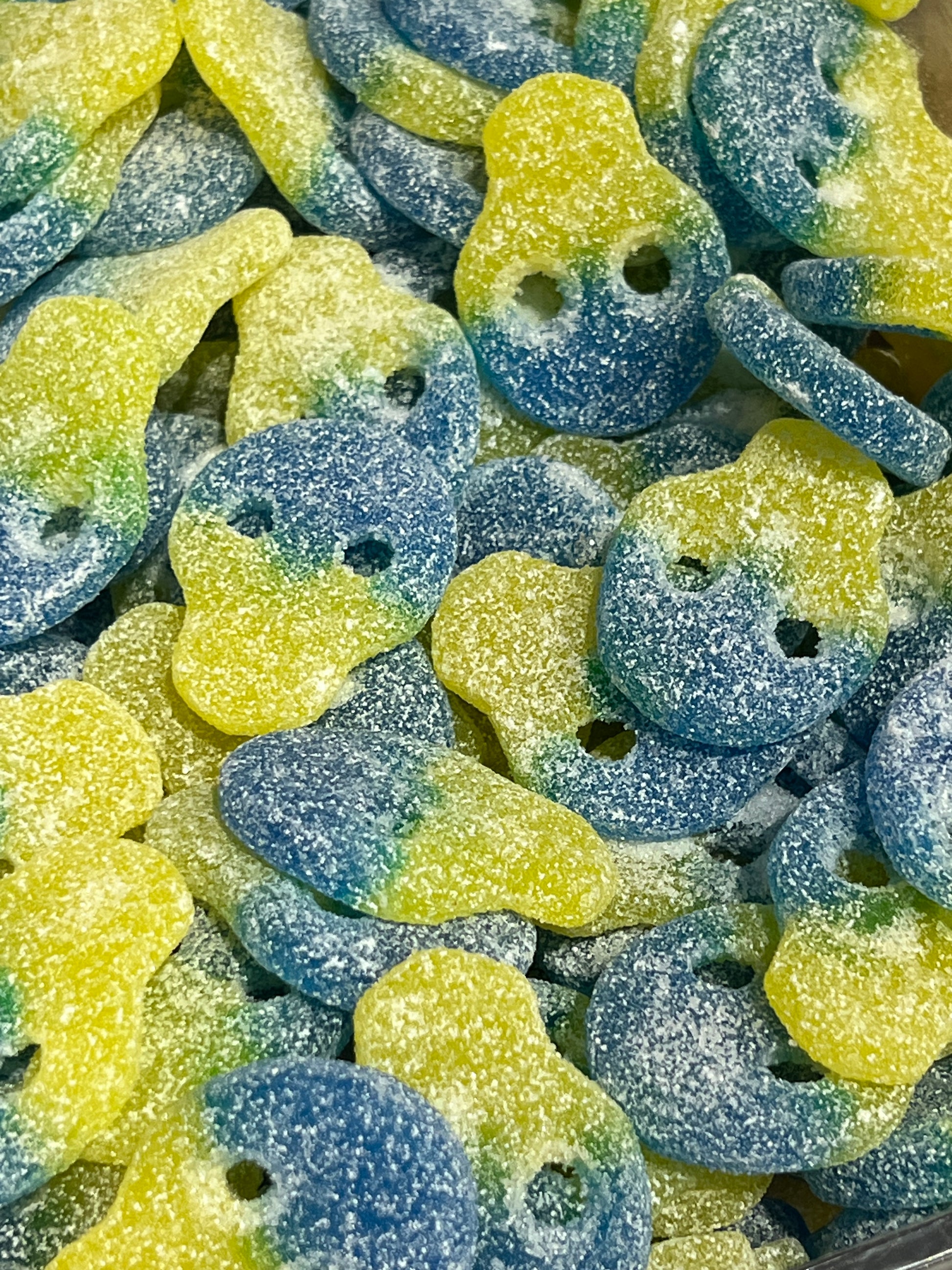Colorful gummy skulls with blue and green hues.