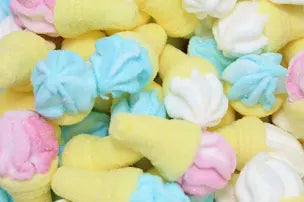 Colorful marshmallow-like candies in various shapes on a white background