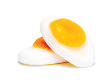 Close up of two marshmallow candy in a shape of fried eggs.