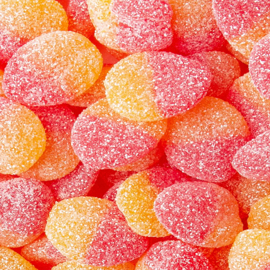Close-up of colorful gummy candies with a sugary texture. Peach color and taste.